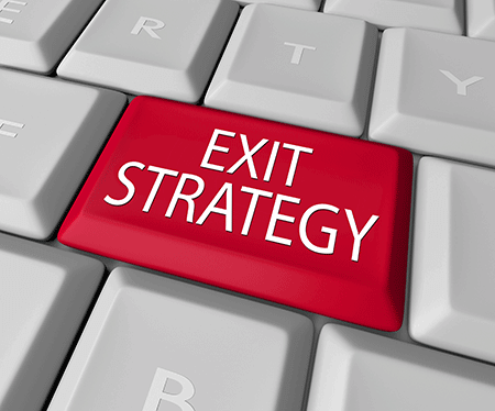 Keyboard with the words exit strategy to help with wealth creation