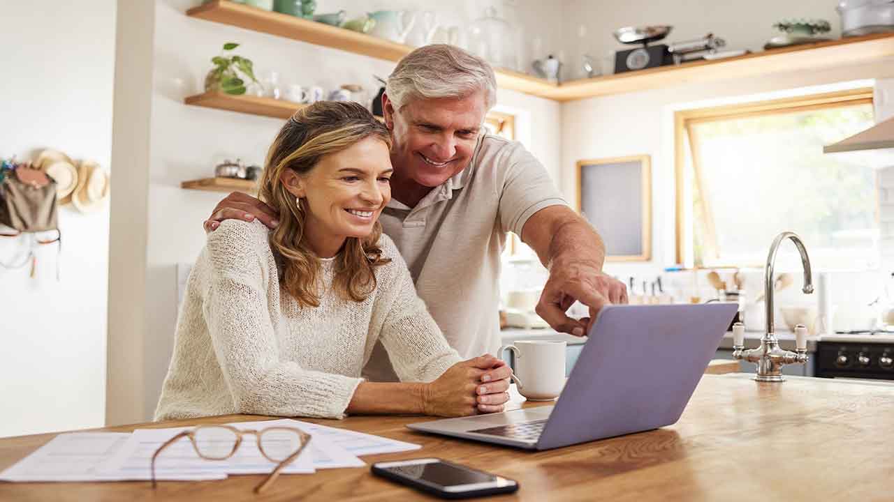 happy couple reviewing their investment portfolio