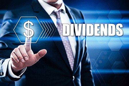 man pointing at a dollar sign with the words dividends and dividend reinvestment plans