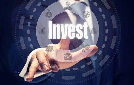 man pointing at a computer screen with the words invest