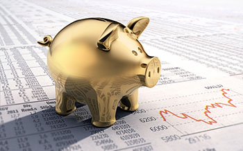 piggy bank sitting on a newspaper