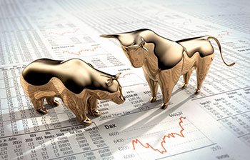 bull and bear standing on a newspaper