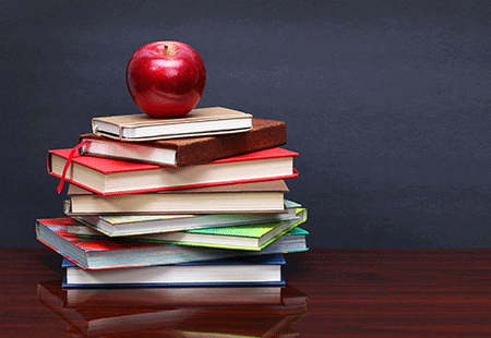 books sitting on a table to educate yourself about wealth creation